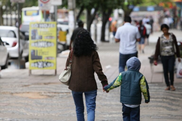 Mostrar pessoas andando na rua com blusa de frio